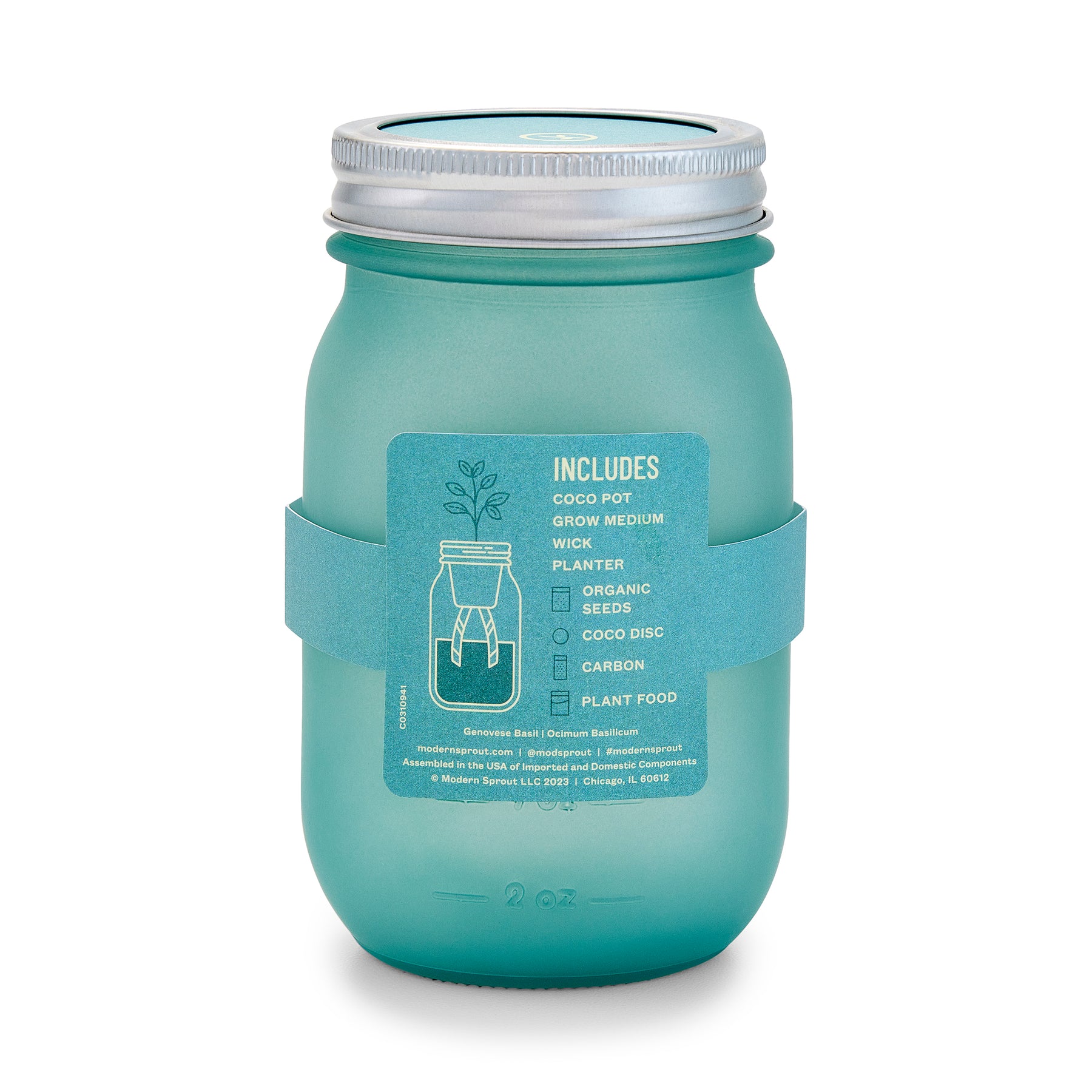 Teal garden jar with a silver lid, featuring a label that lists included items for planting, such as seeds and plant food.