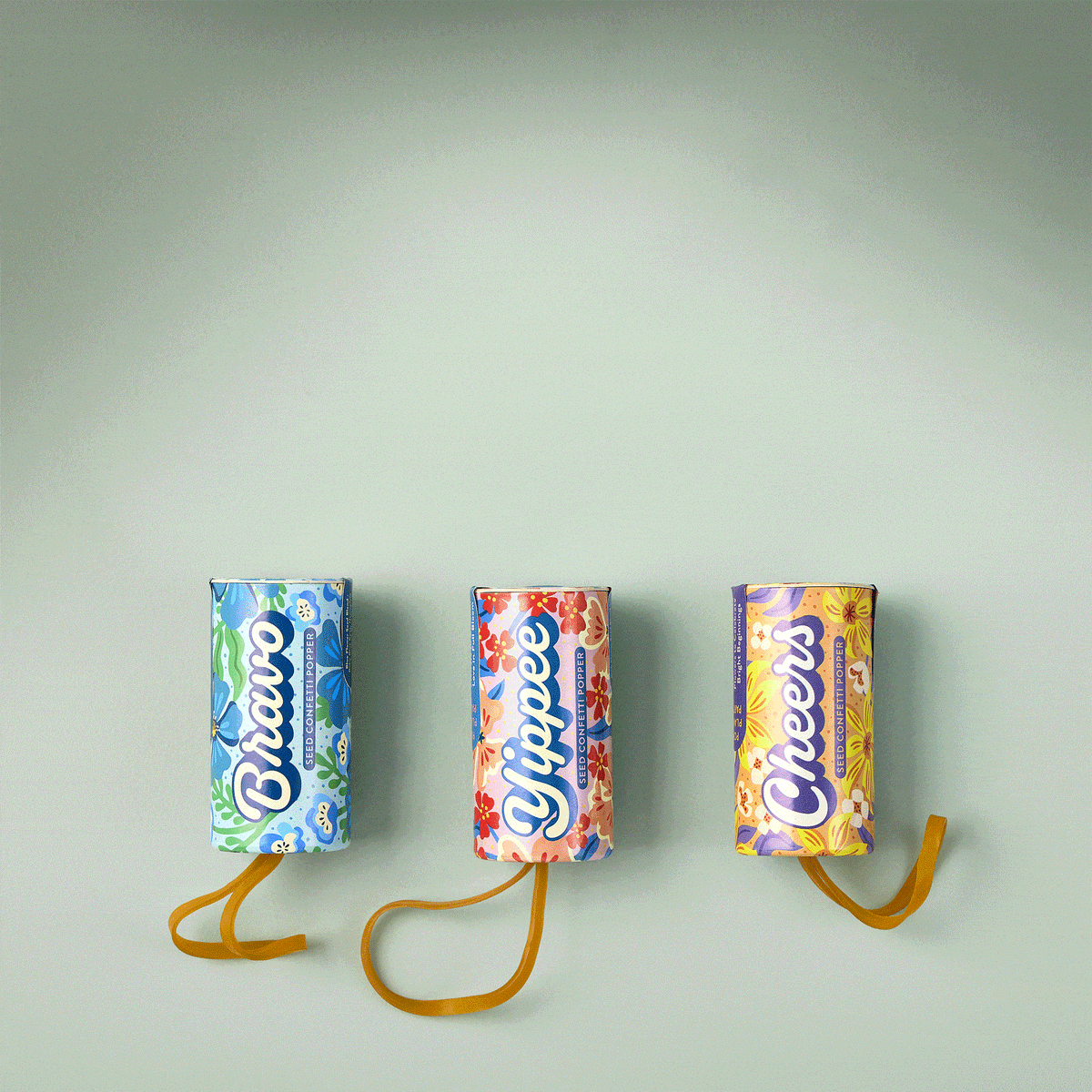 Colorful seed confetti poppers labeled "Bravo," "Yippee," and "Cheers," designed for festive planting celebrations.