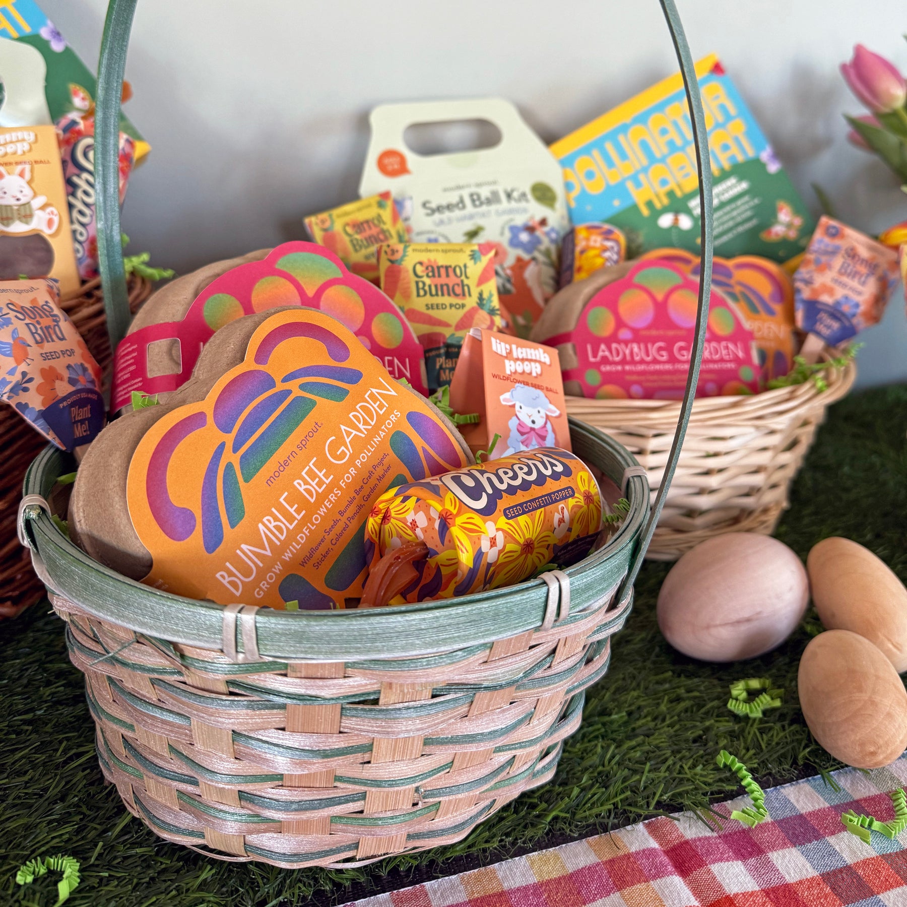 Colorful limited edition Easter baskets filled with themed treats and gardening kits, displayed on a grassy surface.