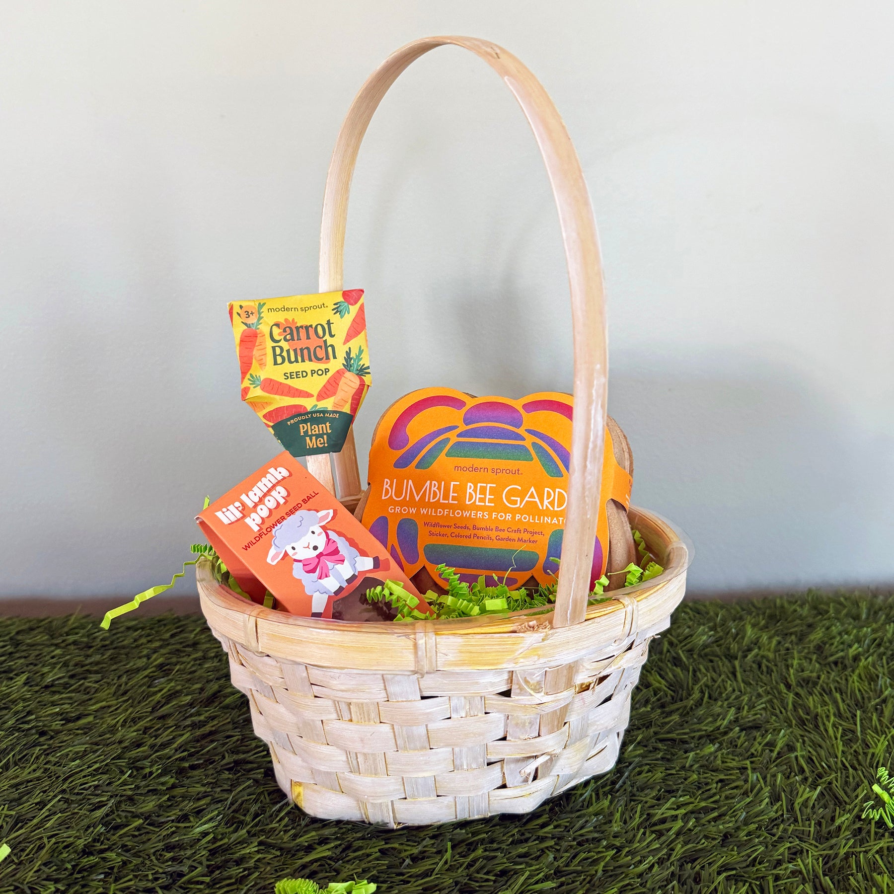 Limited edition Easter basket featuring seed packets for carrots and wildflowers, nestled in green filler.