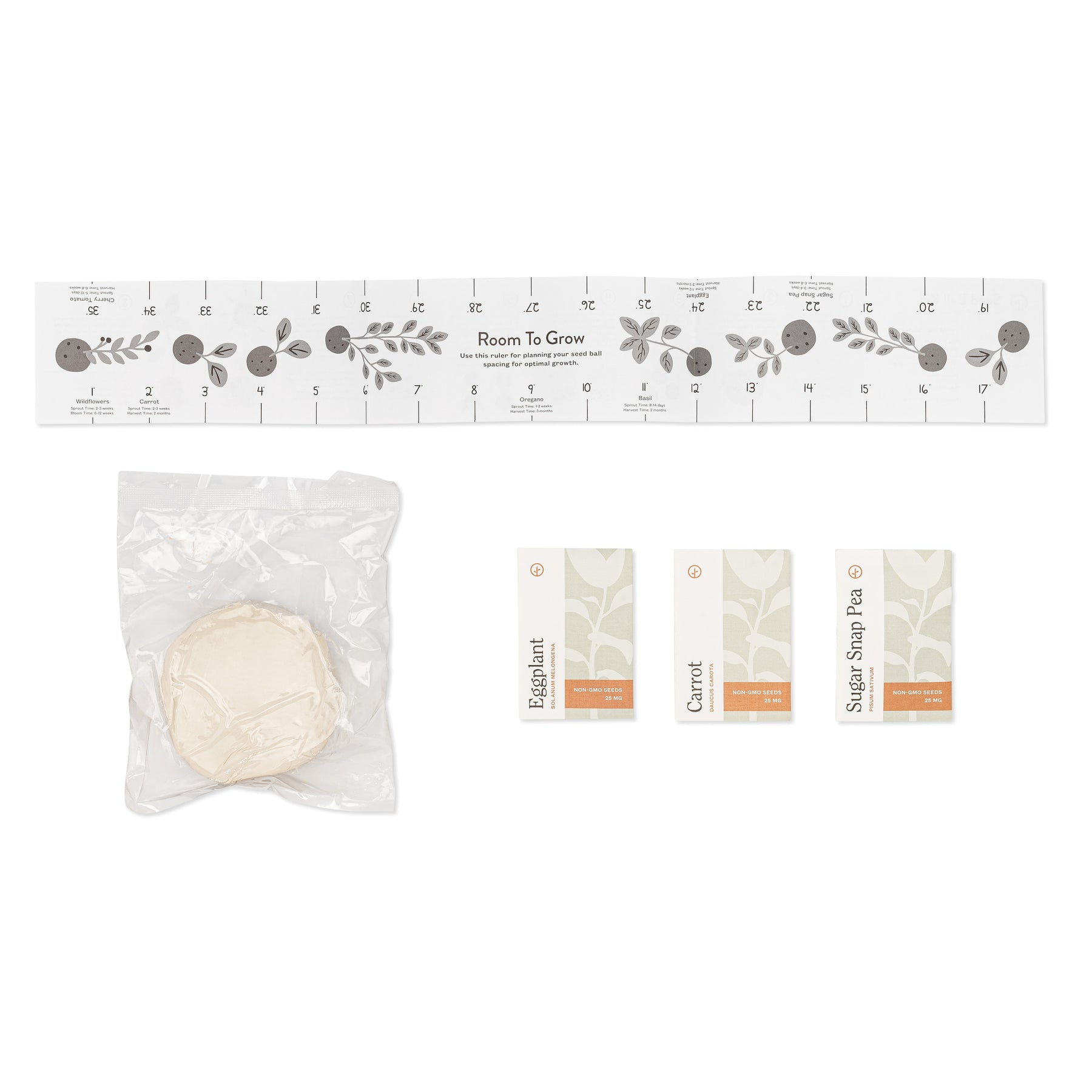 Seed ball kit featuring a planting guide, a seed ball, and seed packets for eggplant, carrot, and sugar snap pea.
