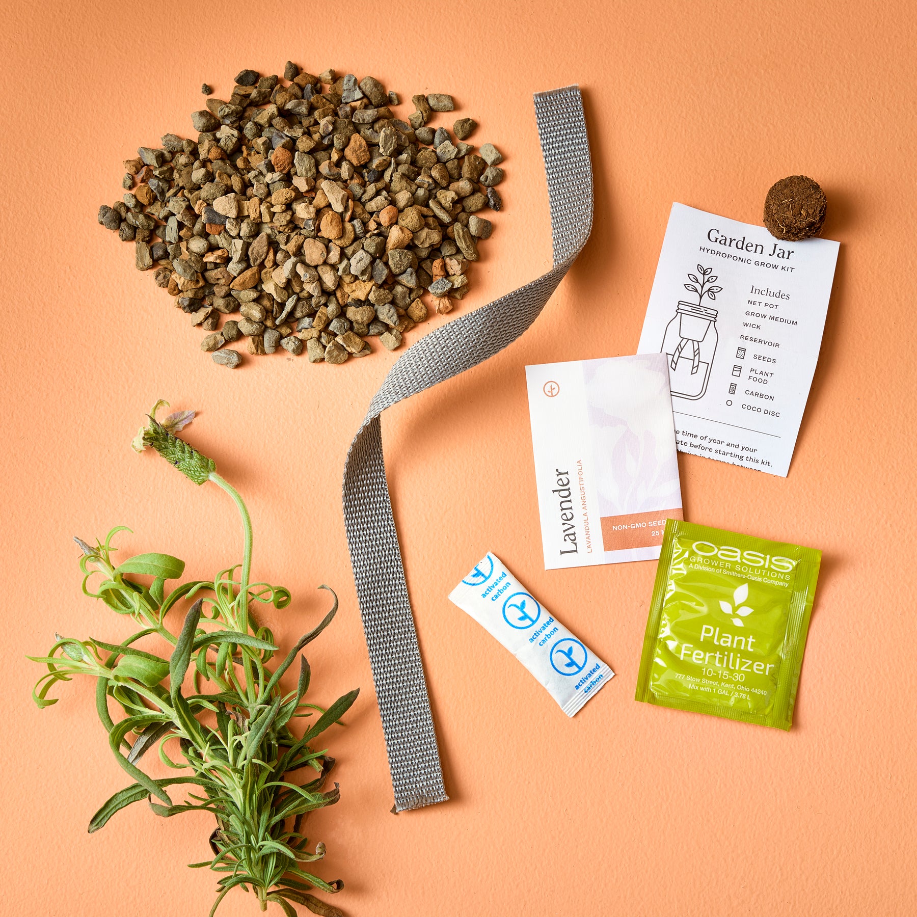 Passive Hydroponic Replant Kit components including gravel, a planting jar, lavender seeds, fertilizer, and a planting medium.