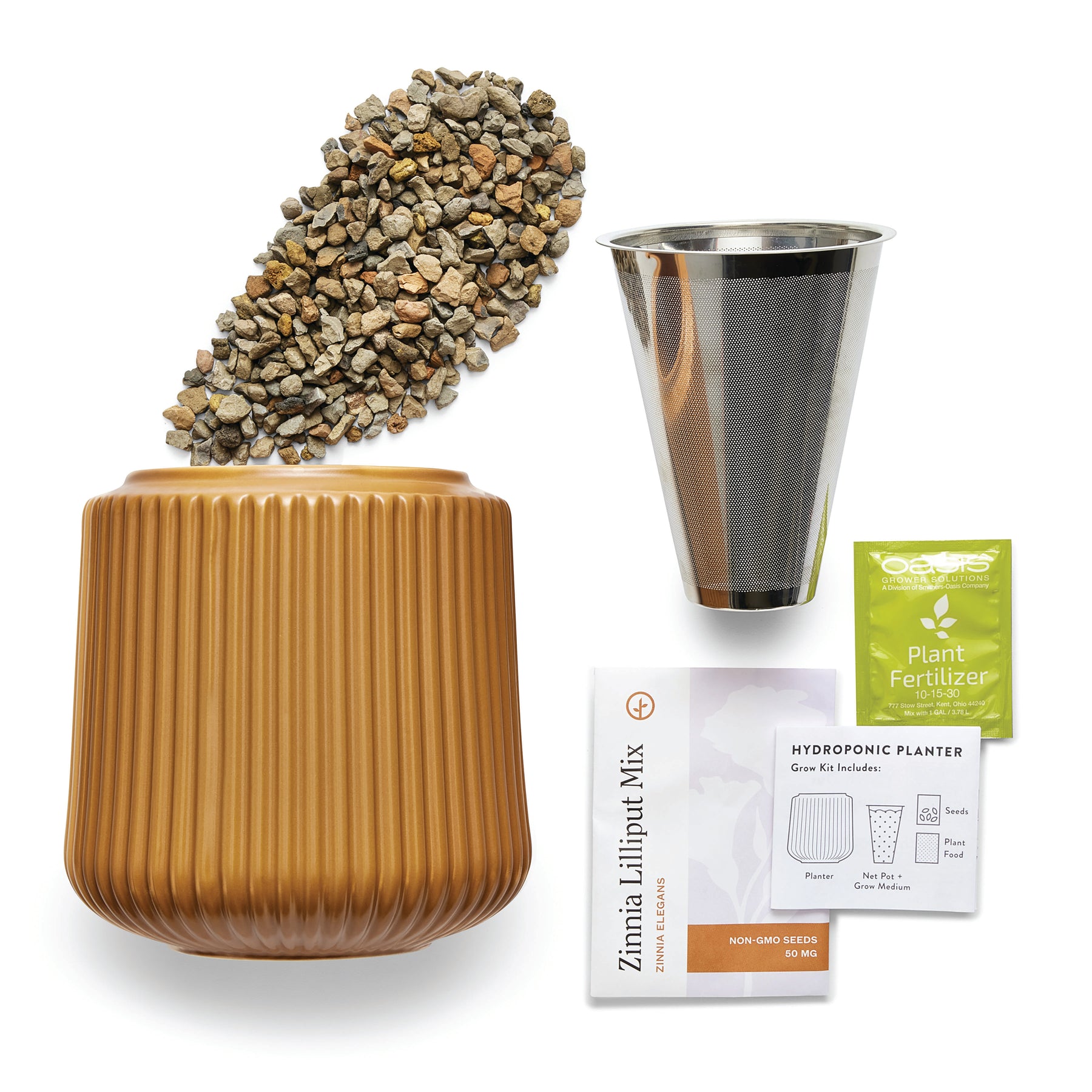 Flower grow kit featuring a ribbed planter, a metal mesh insert, plant fertilizer, and a bag of hydroponic mix.