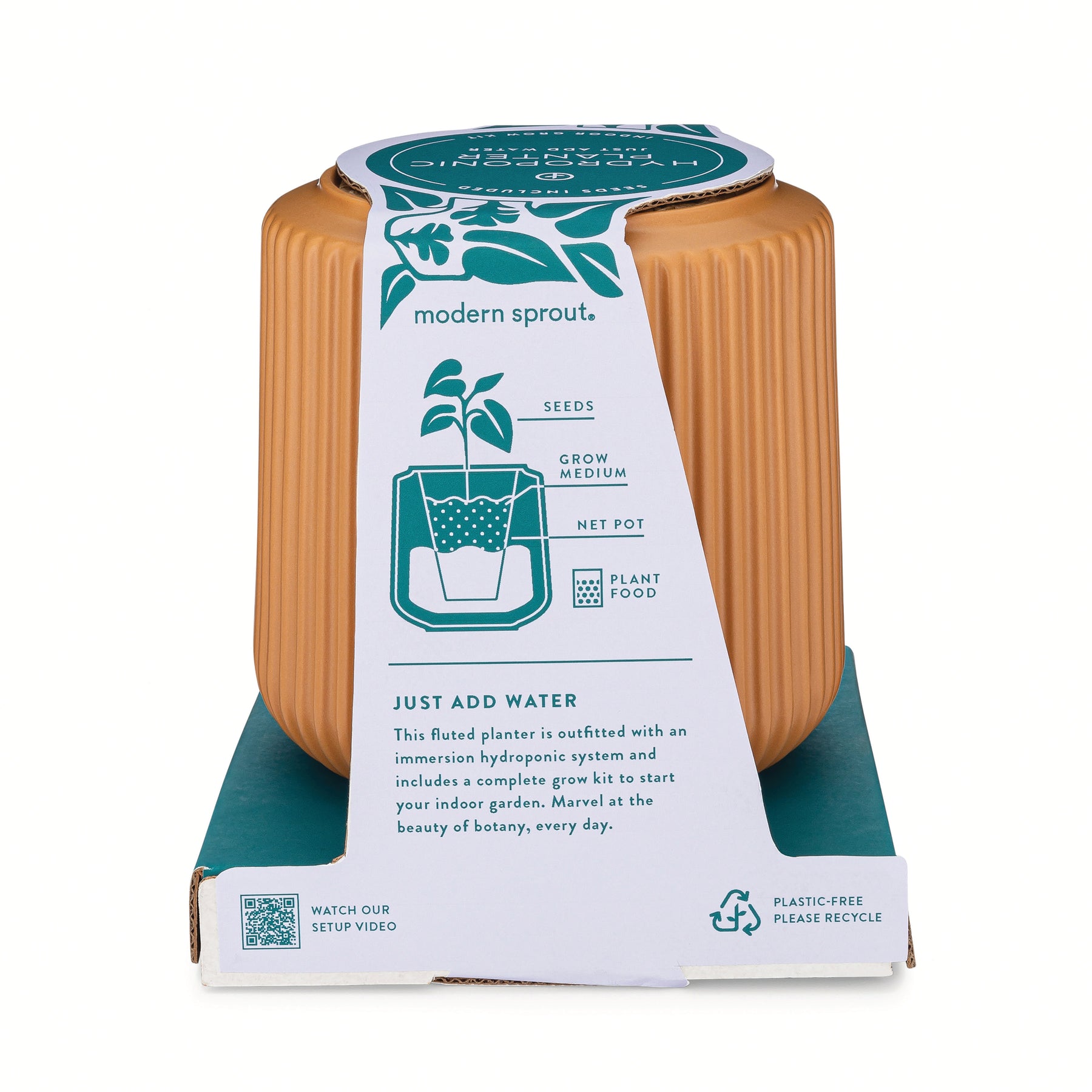 Flower grow kit featuring a ribbed planter, seed packets, grow medium, and plant food for easy indoor gardening.