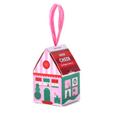 Colorful ornament kit shaped like a house, designed for growing peppermint, featuring festive graphics and a hanging ribbon.