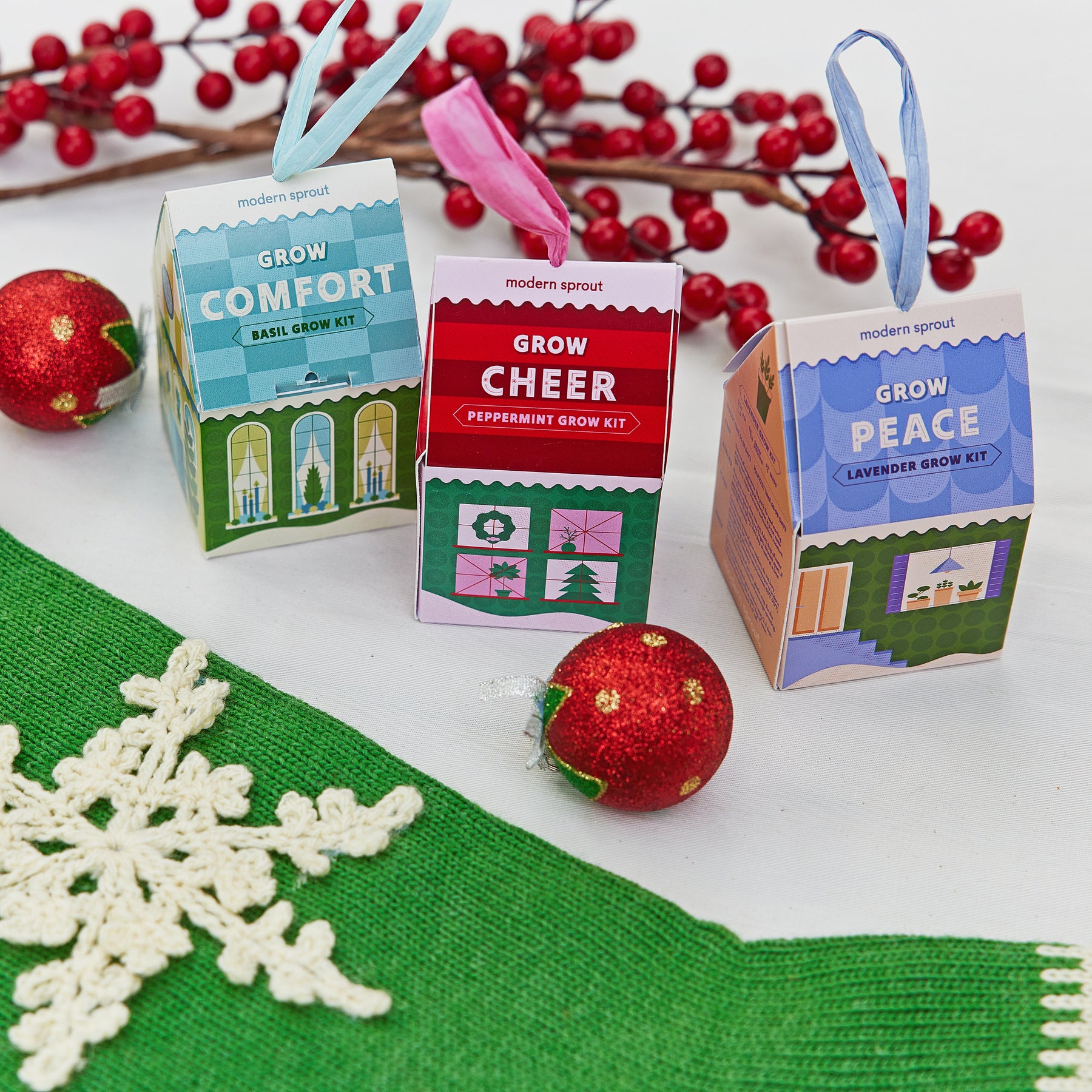 Colorful Home Grown Ornaments featuring herb grow kits for basil, peppermint, and lavender, arranged with festive decorations.