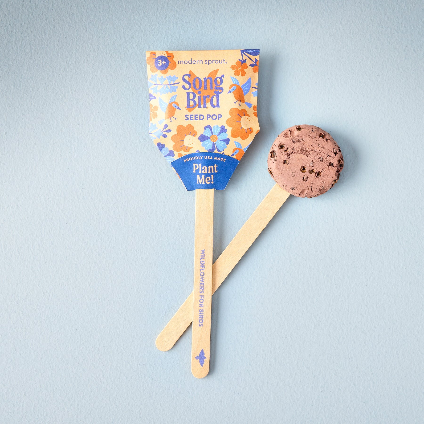 Seed Pops Pollinator with a colorful packaging featuring flowers and a wooden stick for planting.