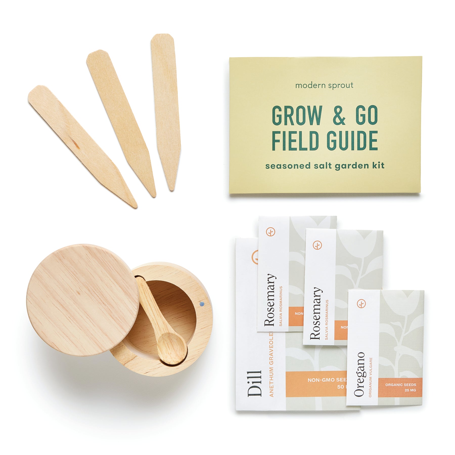 Seed collection kit featuring wooden plant markers, a guide, and packets of dill, rosemary, and oregano seeds.