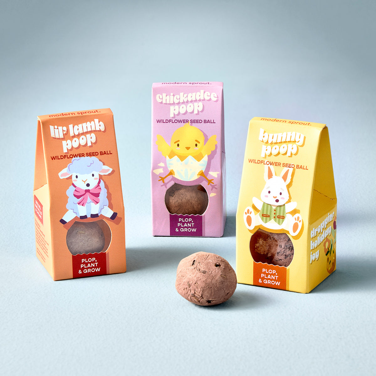 Colorful seed balls for planting wildflowers, packaged as Easter-themed "poop" products: lamb, chick, and bunny designs.
