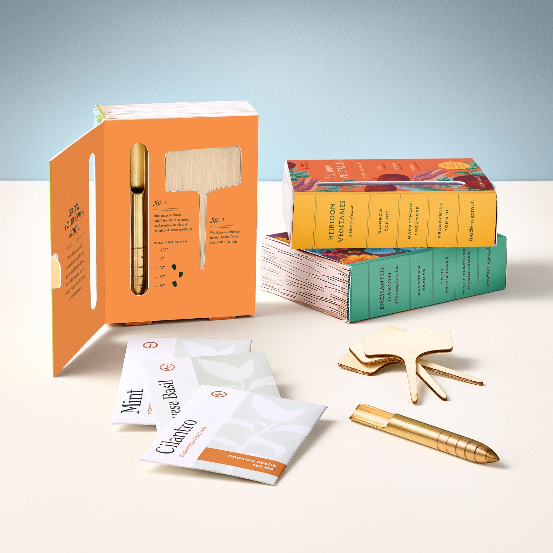 Seed library kit featuring colorful seed packets, a planting guide, and a gold pen for labeling. Ideal for gardening enthusiasts.