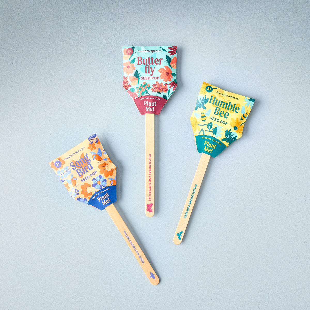Three Seed Pops from Modern Sprout labeled Butterfly, Humble Bee, and Song Bird, each with colorful floral designs.