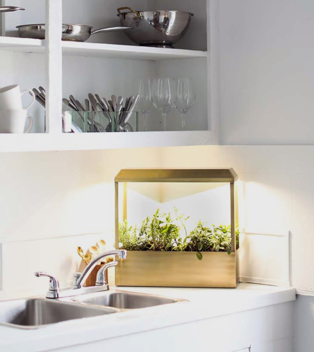 Wooden indoor herb garden kit with LED grow light, placed on a kitchen counter with green herbs.