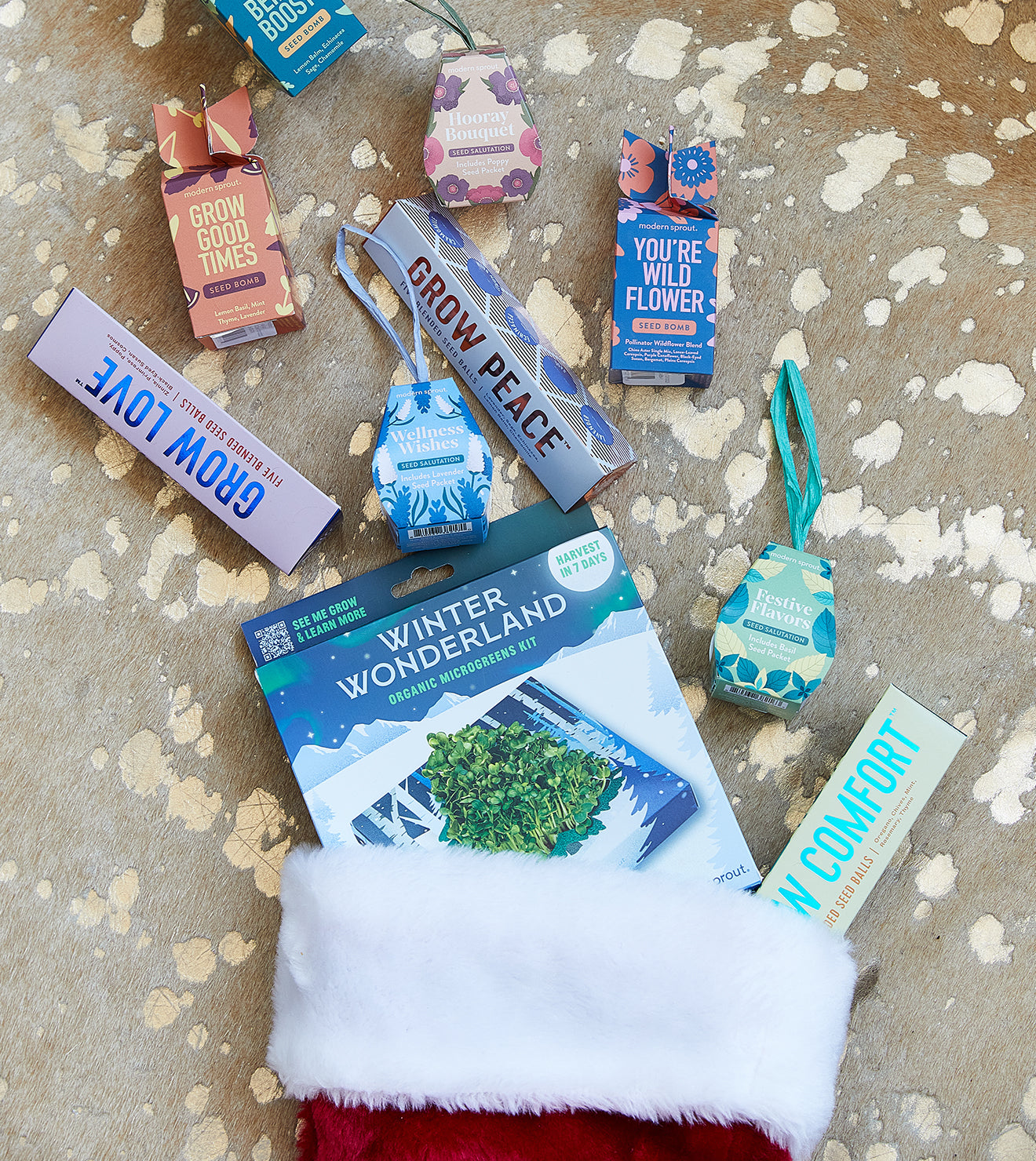 Set of colorful seed bomb packages with herbal and floral blends, winter microgreens kit, and plant accessories for indoor...