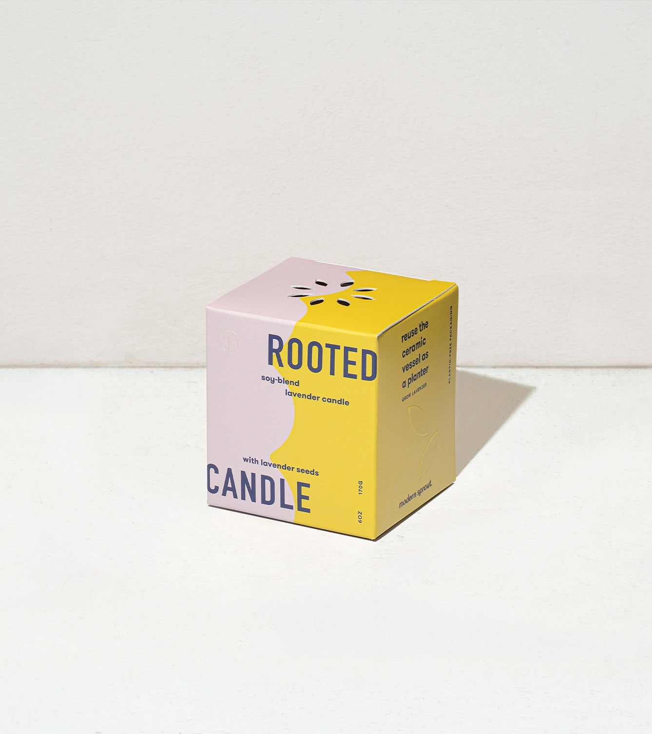 Lavender candle packaging featuring a colorful design with the word "Rooted" prominently displayed.