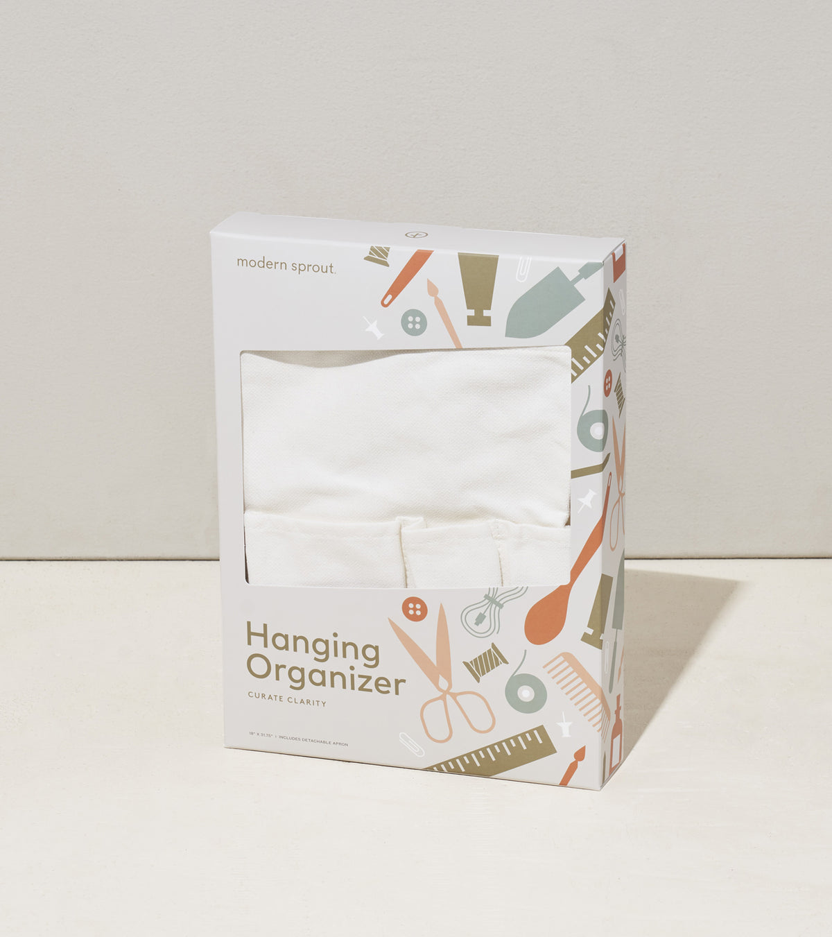 White hanging organizer and apron packaged in a decorative box featuring various gardening tools and accessories.