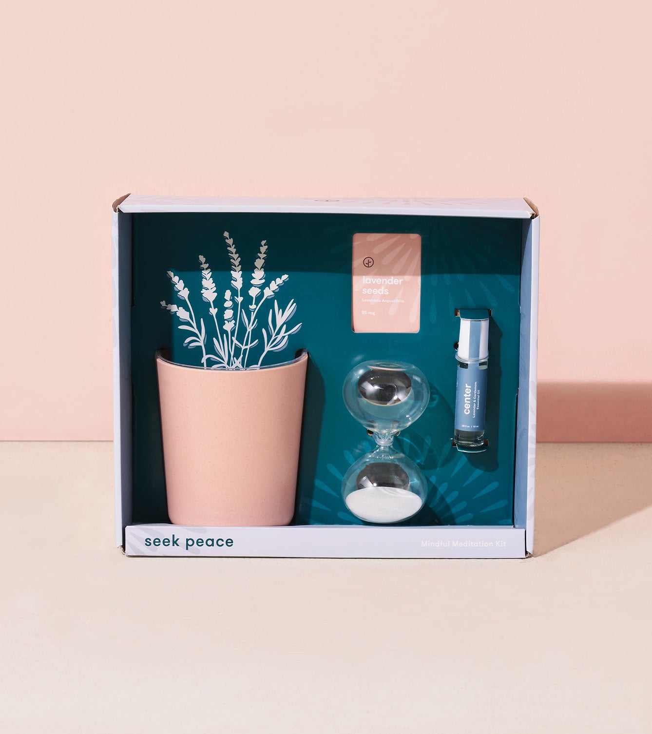 Mindful meditation kit featuring a pink planter with illustrated plants, an hourglass, and a calming essential oil.