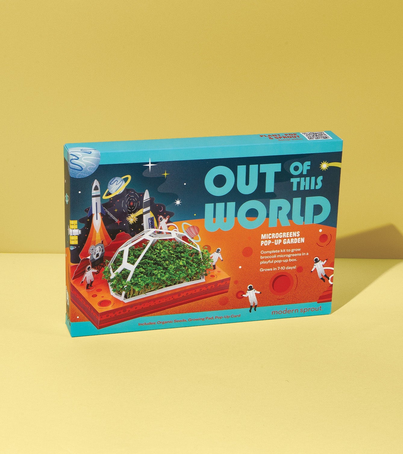 Microgreens Pop-Up Kit box featuring vibrant graphics of astronauts and a mini garden, set against a yellow background.