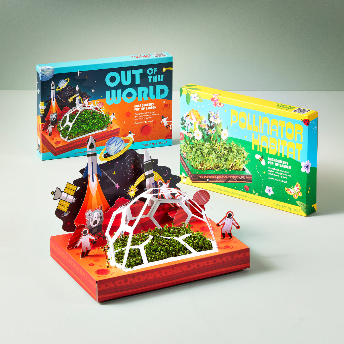 Microgreens Pop-Up Kit featuring two themed boxes: "Out of This World" and "Pollinator Habitat," with vibrant designs and a mini garden setup.