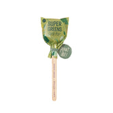 Seed lollipop featuring a colorful wrapper with "Super Greens" label, attached to a wooden stick for planting.