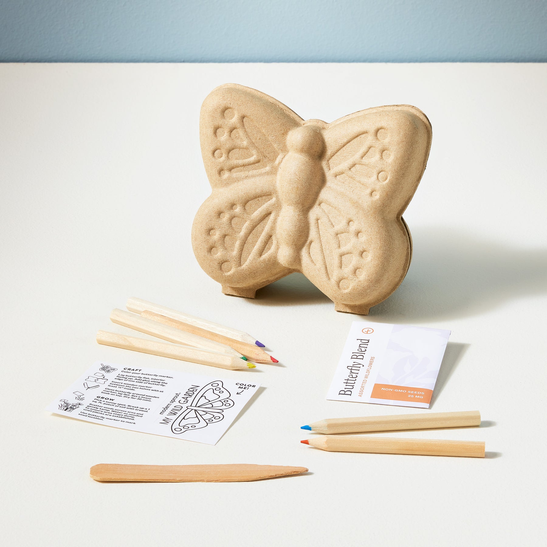 Curious Critters Garden Kit featuring a butterfly-shaped planter, colored pencils, and planting instructions.