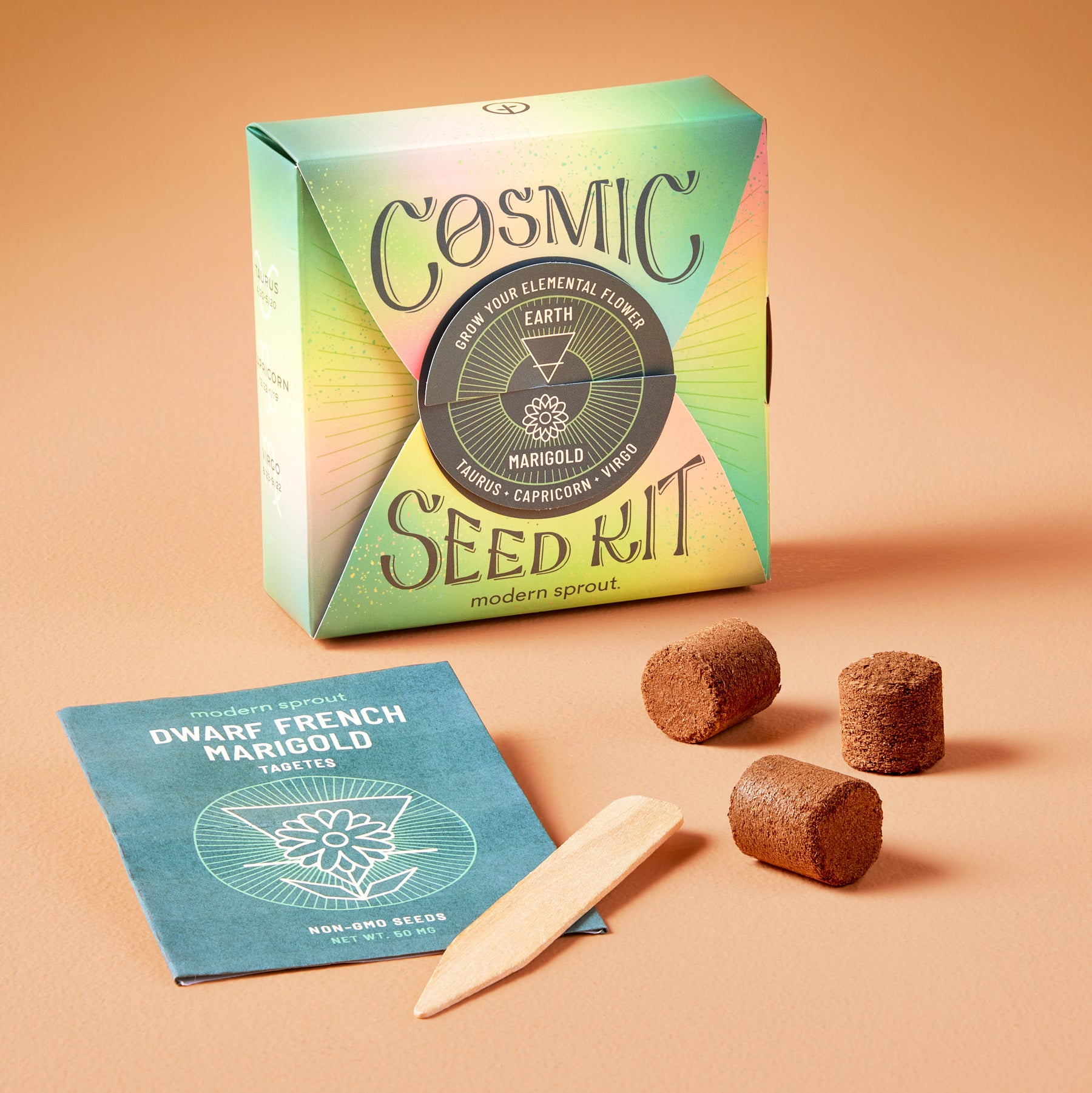 Cosmic Seed Kit packaging with seed packets, soil discs, and a planting stick for growing marigolds.
