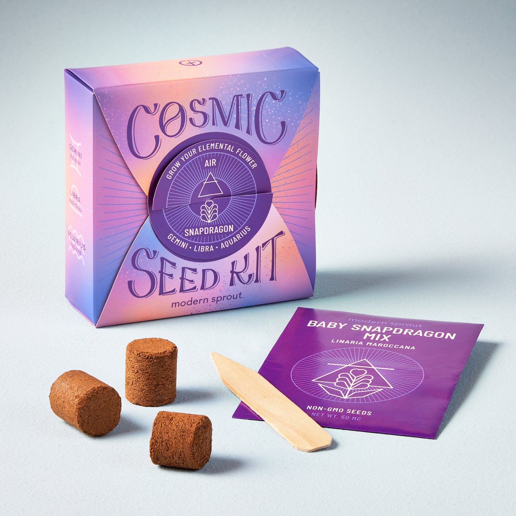 Cosmic Seed Kit featuring snapdragon seeds, growing medium, and a planting stick in a colorful box.