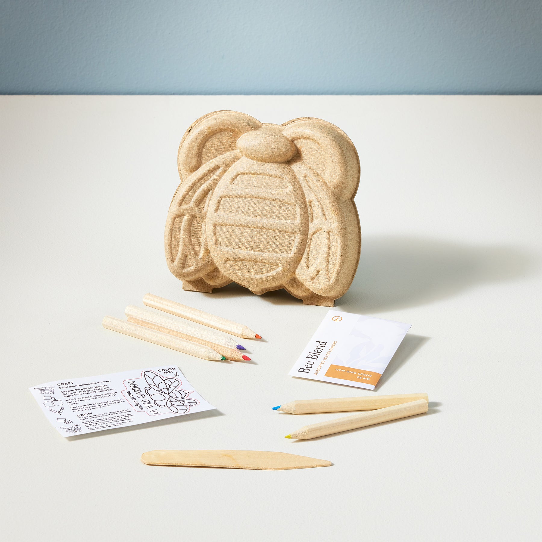 Curious Critters Garden Kit featuring a bee-shaped planter, seed packets, colored pencils, and planting instructions.