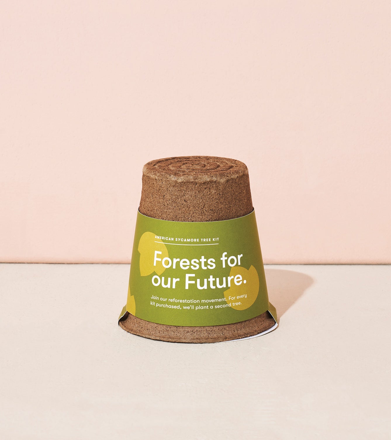 One-For-One Tree Kit featuring a biodegradable pot with a green label promoting reforestation efforts.