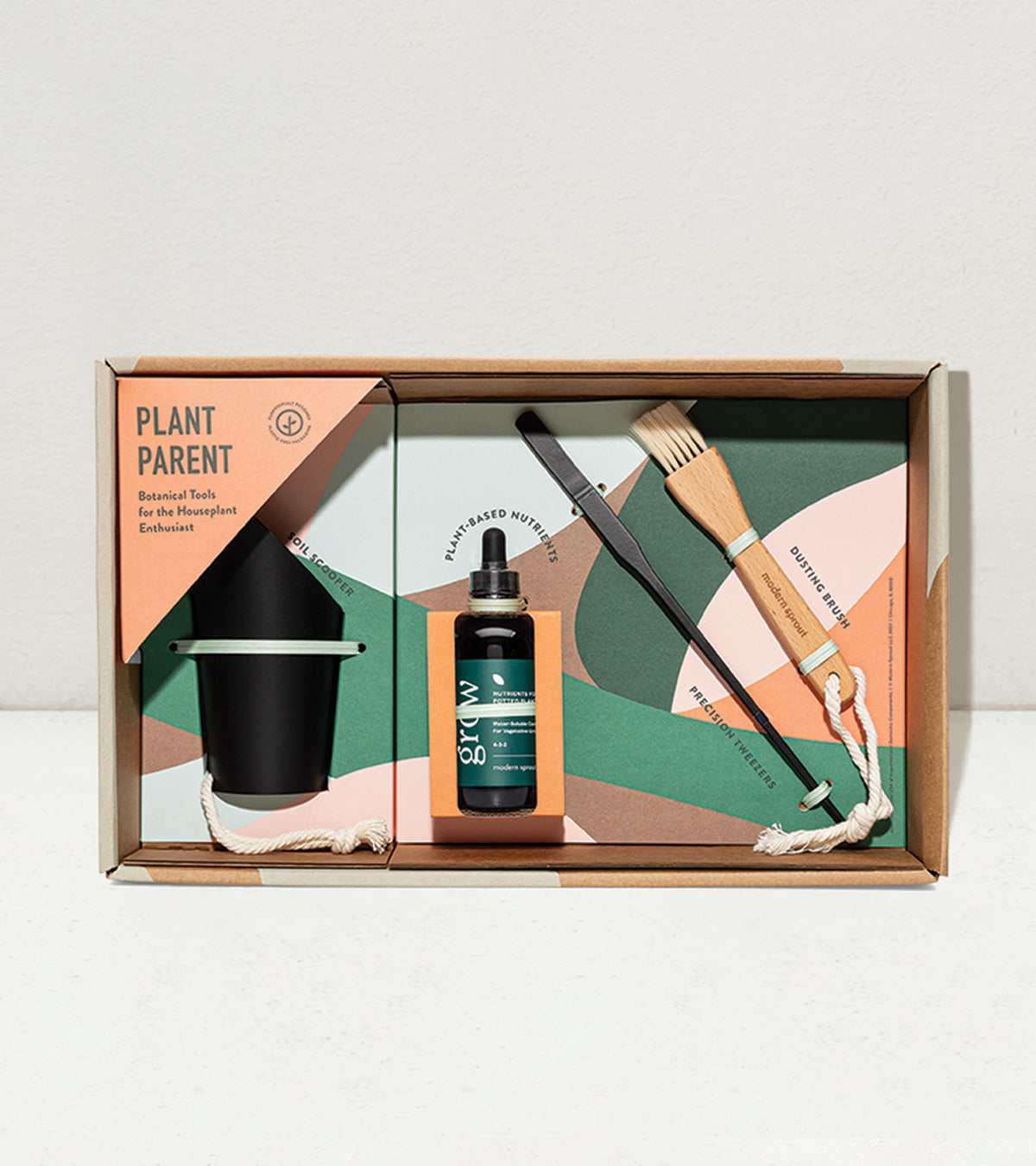 Botanical gift box set featuring a planter, plant care tools, and nutrient solution for plant enthusiasts.