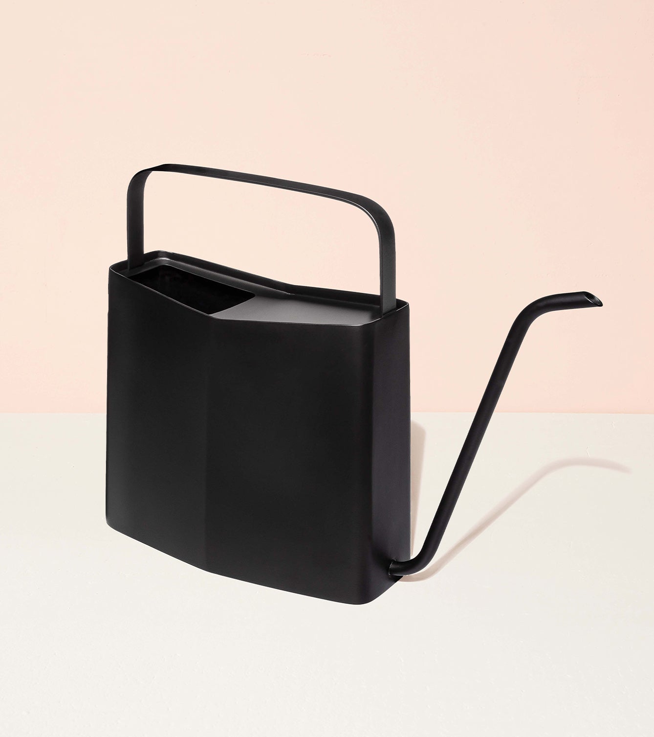 Sleek black watering can with a minimalist design, featuring a long spout and a sturdy handle.