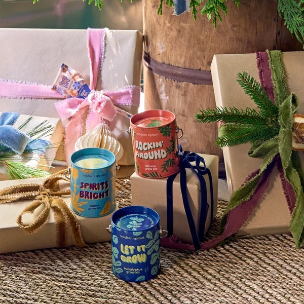 Modern Sprout grow kits in paint can-style tins among wrapped gifts, a corporate gift idea people keep