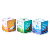 Three colorful candle and planter boxes from Modern Sprout, featuring scents: Spanish Seagull, Eucalyptus, and Lavender.