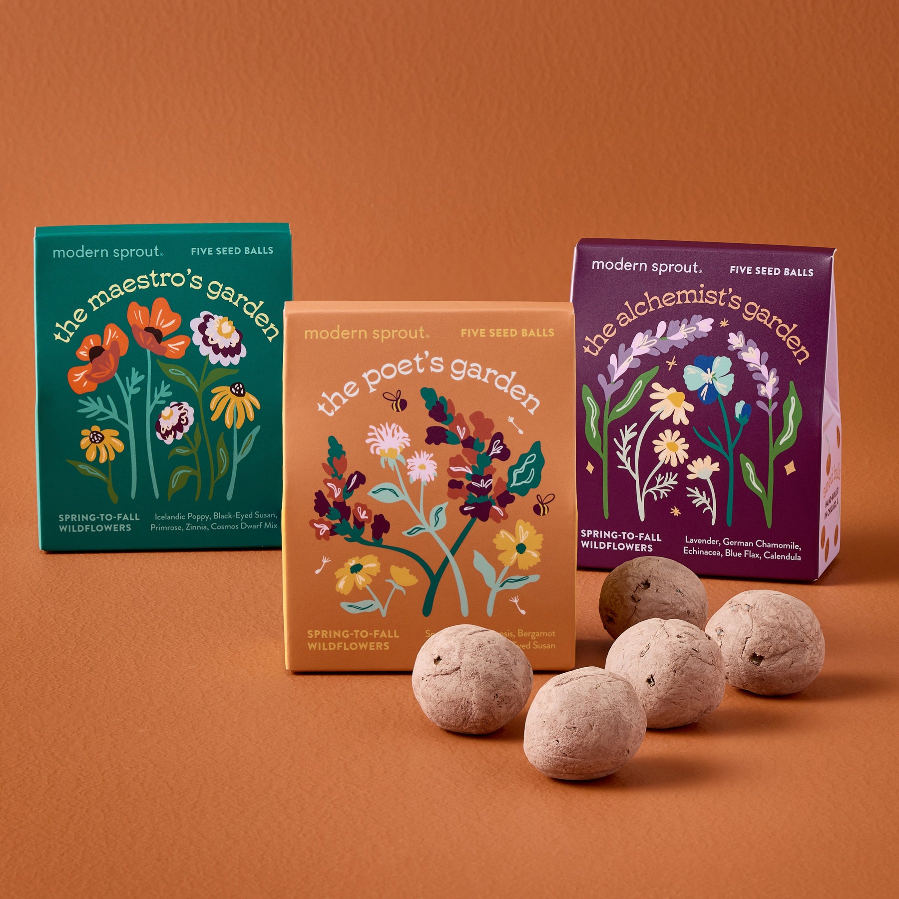Bespoke Blooms Seed Balls packaging featuring three colorful boxes labeled "The Maestro's Garden," "The Poet's Garden," and "The Alchemist's Garden" with seed balls in front.