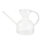 Clear glass watering can with a long spout and a rounded body, designed for easy plant watering.